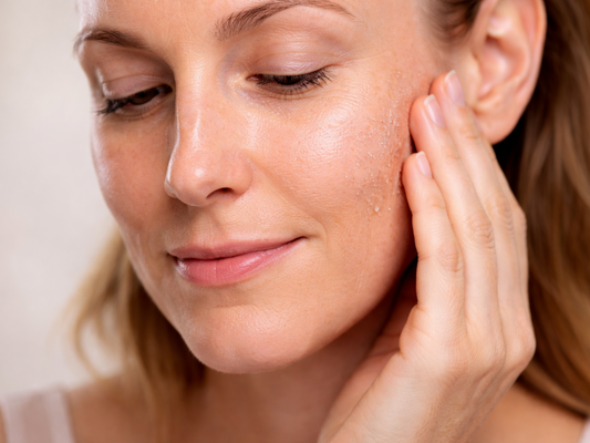 Close-up of a woman’s face showing combination skin with both oily and dry areas on the cheek.
